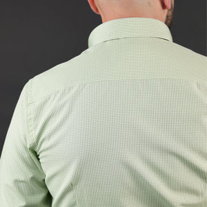 a man with a bald head wearing a green shirt