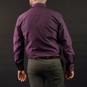 a man in a purple shirt and khaki pants