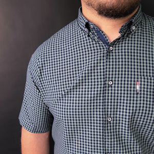 a man with a beard wearing a checkered shirt