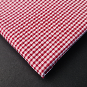 a red and white checkered tie on a black surface