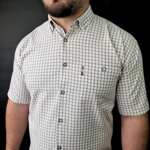 a man with a beard wearing a checkered shirt