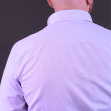 a man with a bald head wearing a purple shirt