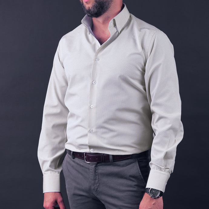a man with a beard wearing a white shirt and gray pants