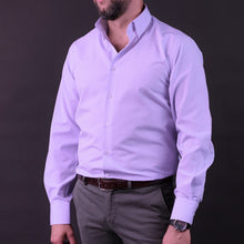 a man in a dress shirt and tie posing for a picture