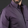 a man with a beard wearing a purple shirt