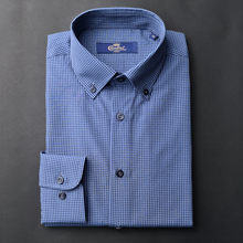 a blue and white checkered shirt on a black surface