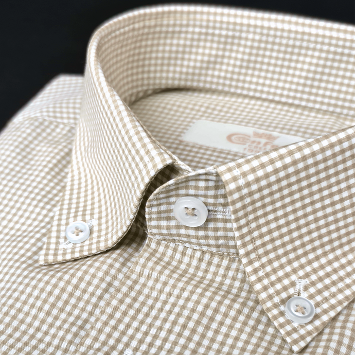 a brown and white checkered shirt with buttons