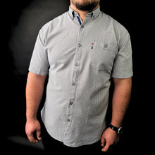 a man in a shirt and tie posing for a picture