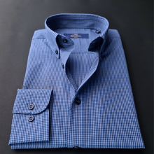 a blue and white checkered shirt on a black surface