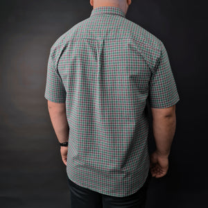 a man in a green and black checkered shirt