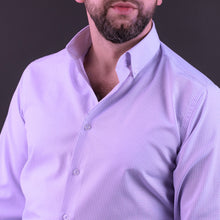 a man with a beard wearing a purple shirt