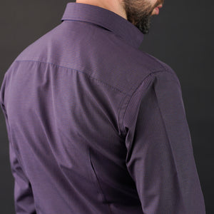 a man with a beard wearing a purple shirt