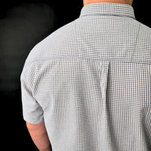 a man wearing a blue and white checkered shirt