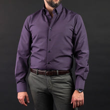 a man with a beard wearing a purple shirt