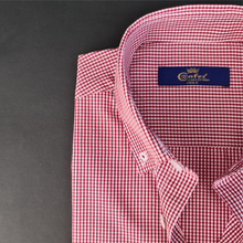 a red and white checkered shirt with a blue label