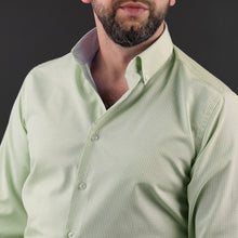 a man with a beard wearing a green shirt