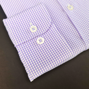 a close up of a purple and white checkered shirt