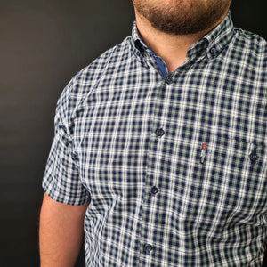 a man with a beard wearing a plaid shirt