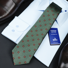 a tie, shirt and dress shoes on a table