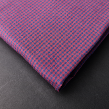 a close up of a pink and blue checkered tie