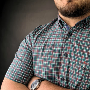 a man with his arms crossed wearing a watch