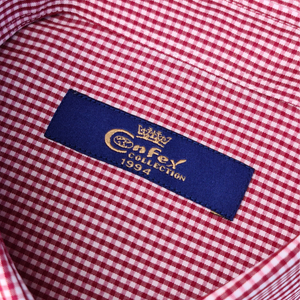 a red and white checkered shirt with a blue label