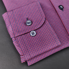 a close up of a pink and blue checkered shirt