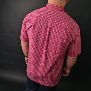 a man wearing a red and white checkered shirt