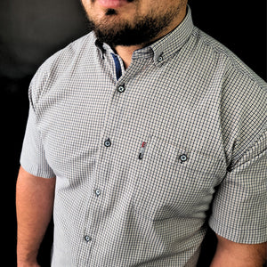 a man with a beard wearing a checkered shirt