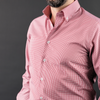 a man with a beard wearing a pink shirt