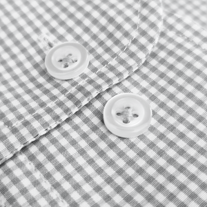 a close up of two buttons on a shirt