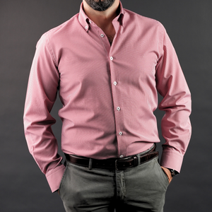 a man in a pink shirt is posing for a picture